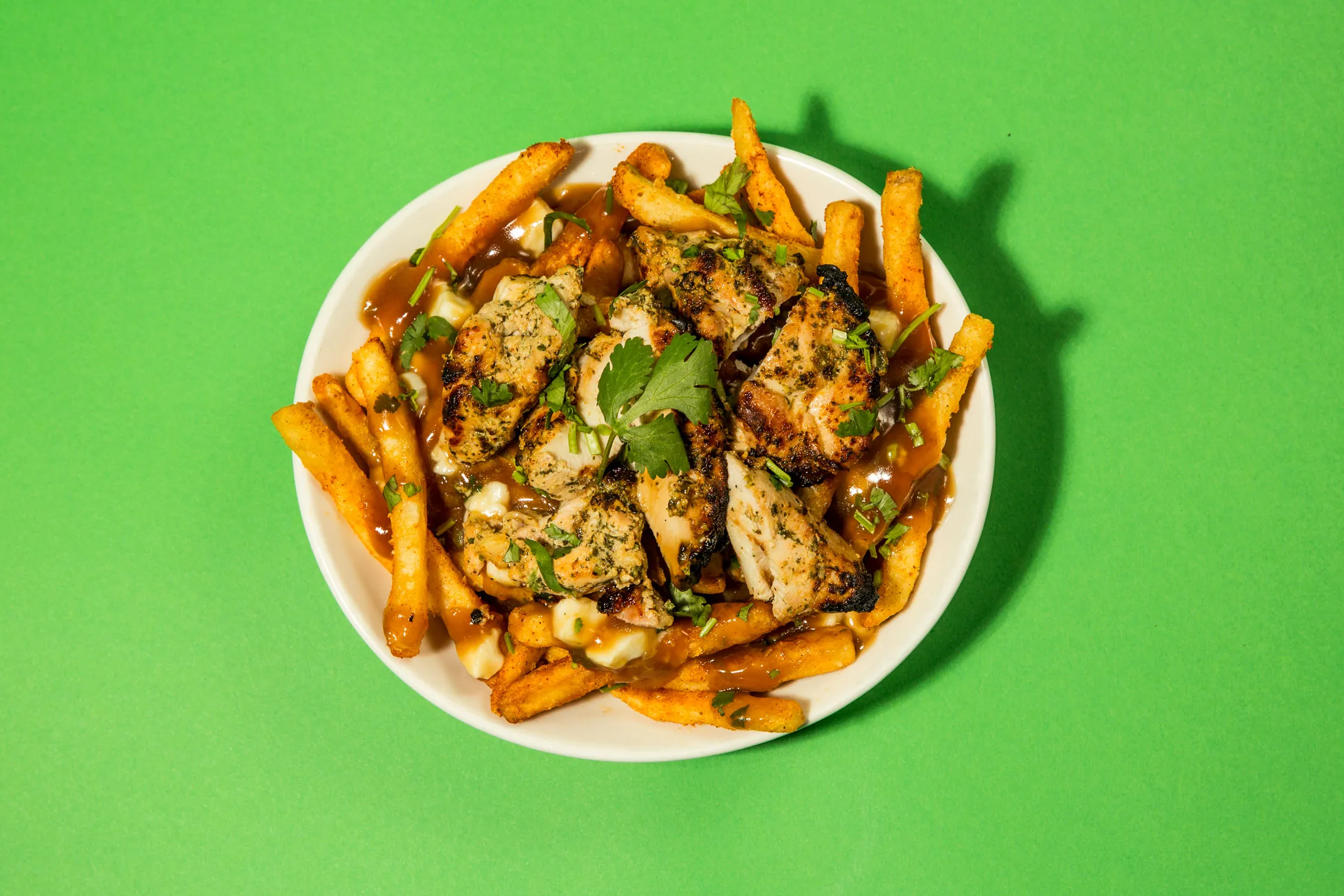 Chicken Tikka Poutine: Badmaash spices up Canada’s comfort food, dusting french fries with kala namak (black salt), paprika, and dried mango powder.
