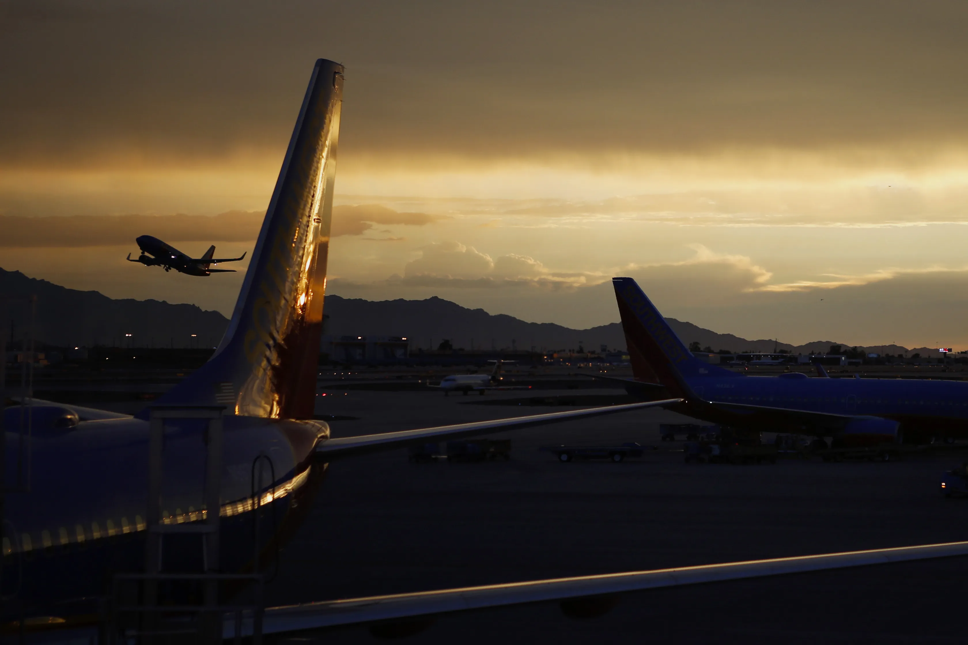 A plane takes off at sunset from Phoenix Sky Harbor International Airport (PHX) in Phoenix, Arizona, U.S.