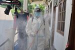 An Indonesian Red Cross member sprays disinfectant in the compounds of a house after one of its dwellers tested positive for Covid-19 in Jakarta on Oct. 7.