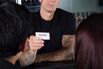 A bartender checking the ID of a customer rf 