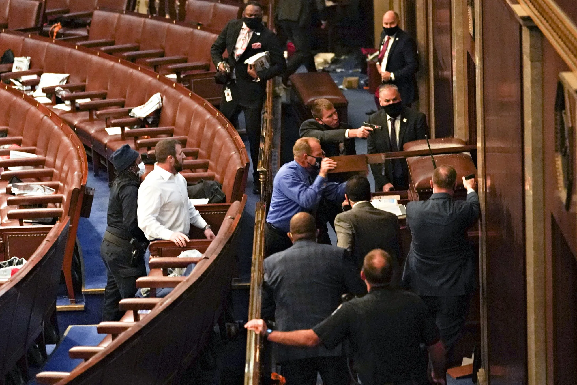 U.S. Capitol police officers point guns at a door during a joint session of Congress to count the votes of the 2020 presidential election in the House Chamber in Washington on Jan. 6, 2021.&nbsp;