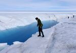 A student looks at a meltwater stream on the Glacial Ice Sheet, Greenland.