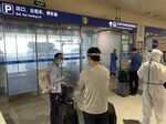 Inbound passengers waiting to be taken to quarantine-designated destinations at the Beijing International Airport on June 18.