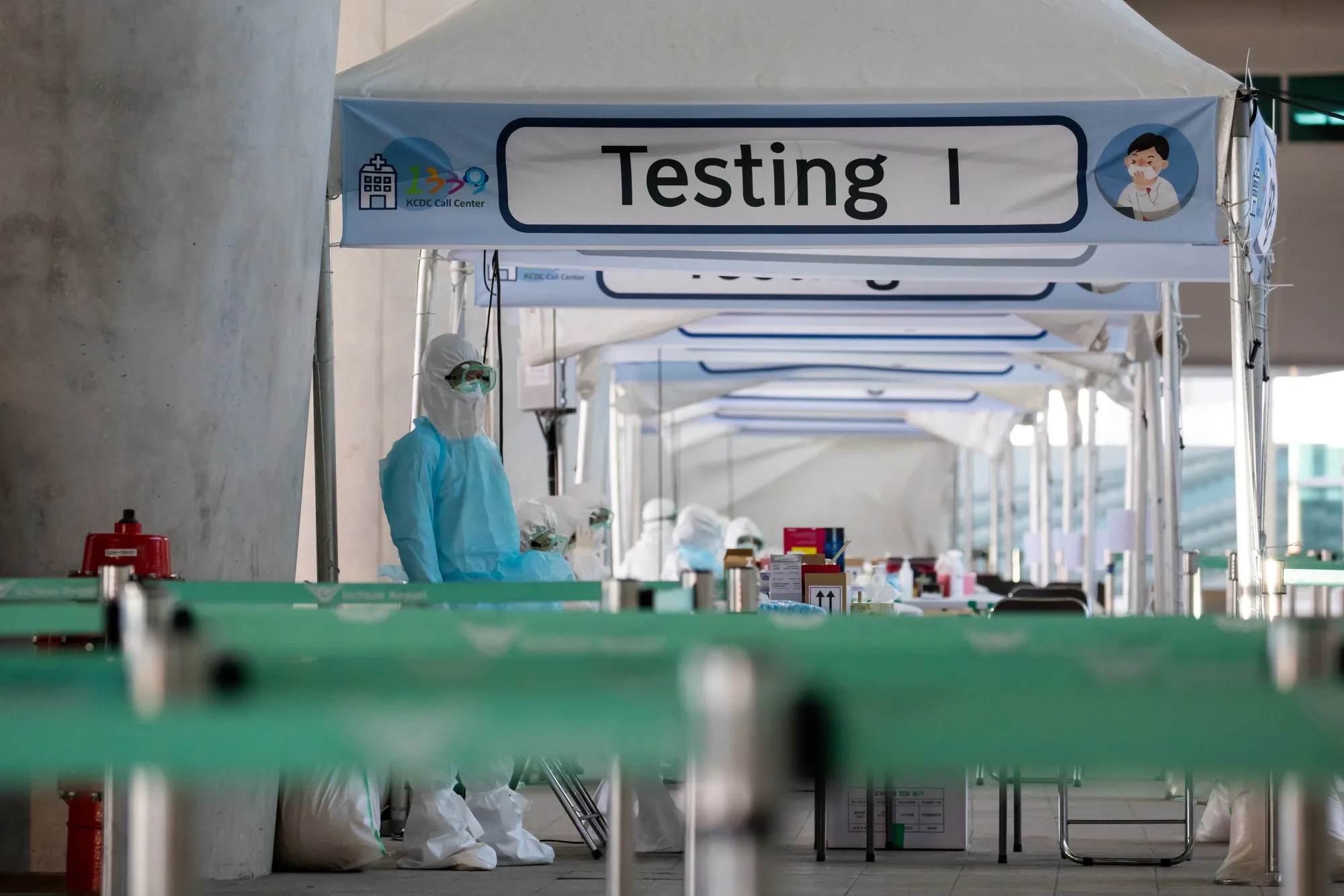 Medical staff wait for passengers at Incheon International Airport in South Korea in April.