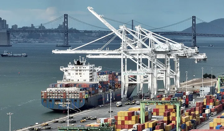 OAKLAND, CALIFORNIA - NOVEMBER 02: In an aerial view, cranes sit idle as a container ship sits docked at the Port of Oakland on November 02, 2022 in Oakland, California. Longshoremen at the Port of Oakland walked off the job and shuttered the port as contract negotiations stall. Longshoremen at the port have been working without a contract since July asking for improved pay and benefits after working nonstop through the COVID-19 pandemic. (Photo by Justin Sullivan/Getty Images)