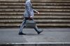 A pedestrian walks along Wall Street near the New York Stock Exchange (NYSE) in New York, U.S., on Wednesday, Sept. 6, 2017. Markets stabilized Wednesday, even as North Korean tensions continued to simmer, another hurricane tore through the Caribbean and a key member of the Fed resigned.