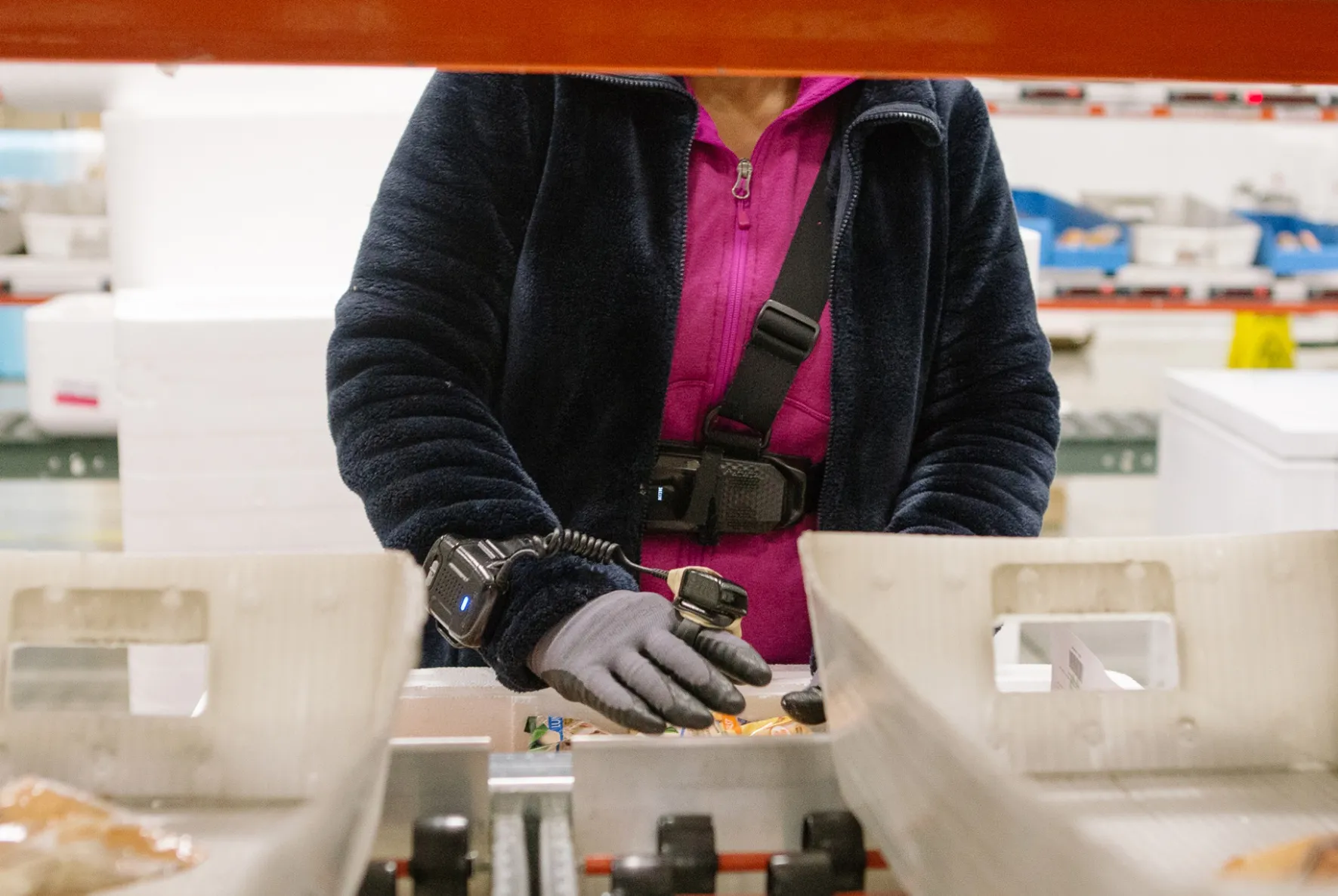 An employee wears a StrongArm harness and device at a Geodis fulfillment center in Breinigsville, Pennsylvania,&nbsp;on Nov. 4.