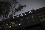 Signage at a Tesla Inc. showroom and service center in Sydney, Australia, on Monday, April 12, 2021. Tesla and the electric-car industry generally thrive in the world’s richest nations. Not so in Australia, where even tractors outsell EVs two to one.