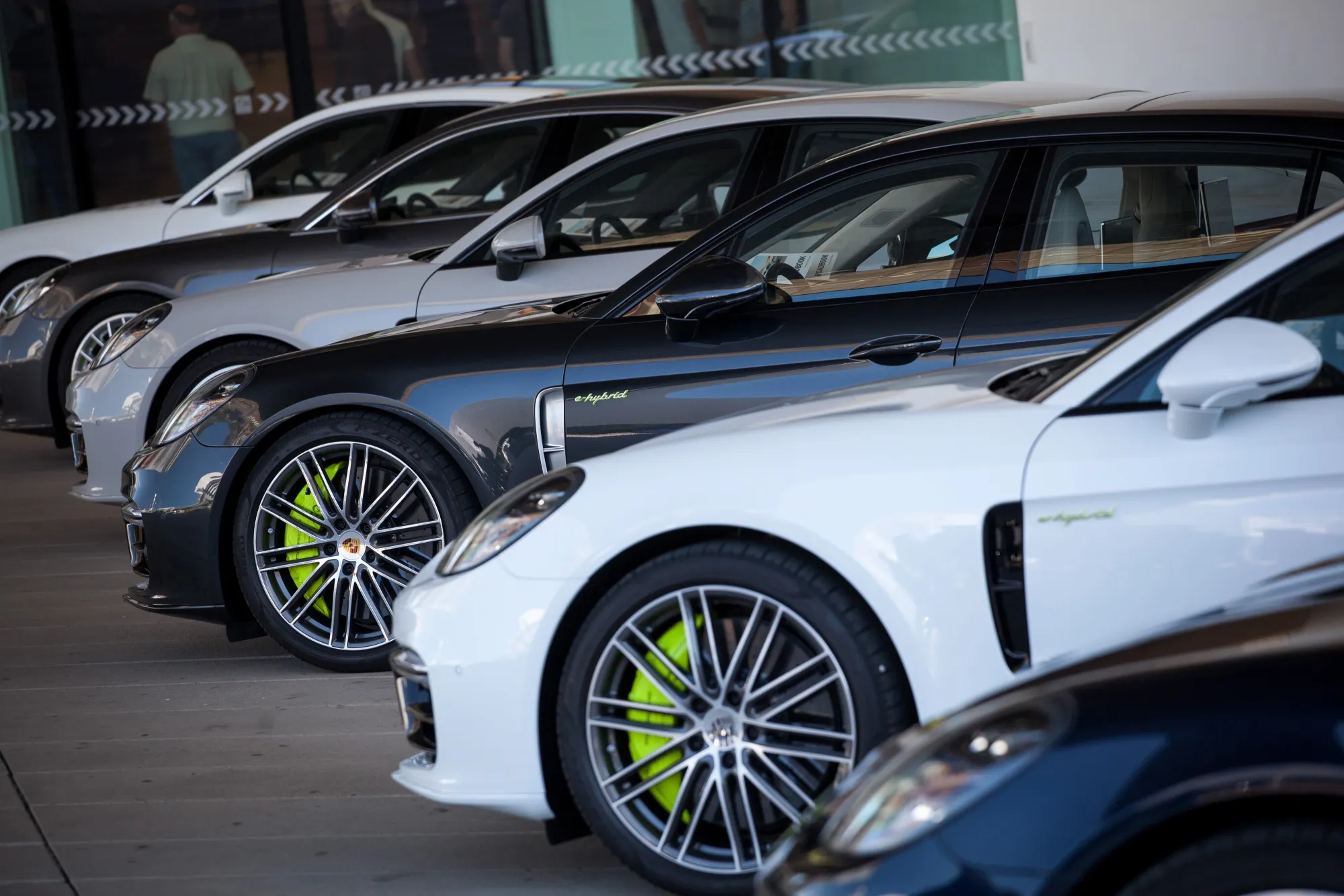 Porsche AG Panamera 4 E-Hybrid luxury automobiles are displayed in front of the luxury automobile maker's museum in Stuttgart, Germany, on Thursday, July 13, 2017. Volkswagen AG's Porsche brand faces a formal probe by German prosecutors as the diesel-emissions scandal spreads to VW's iconic sports-car maker.