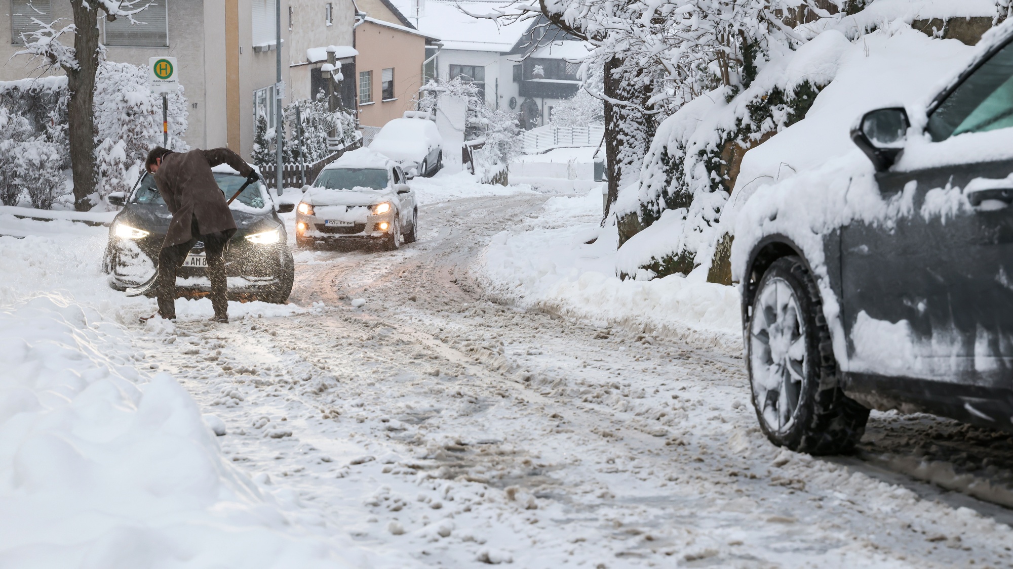 A resident clears snow on a road in Forchheim, Germany, on Jan. 26. Photographer: Daniel Loeb/picture alliance/Getty Images