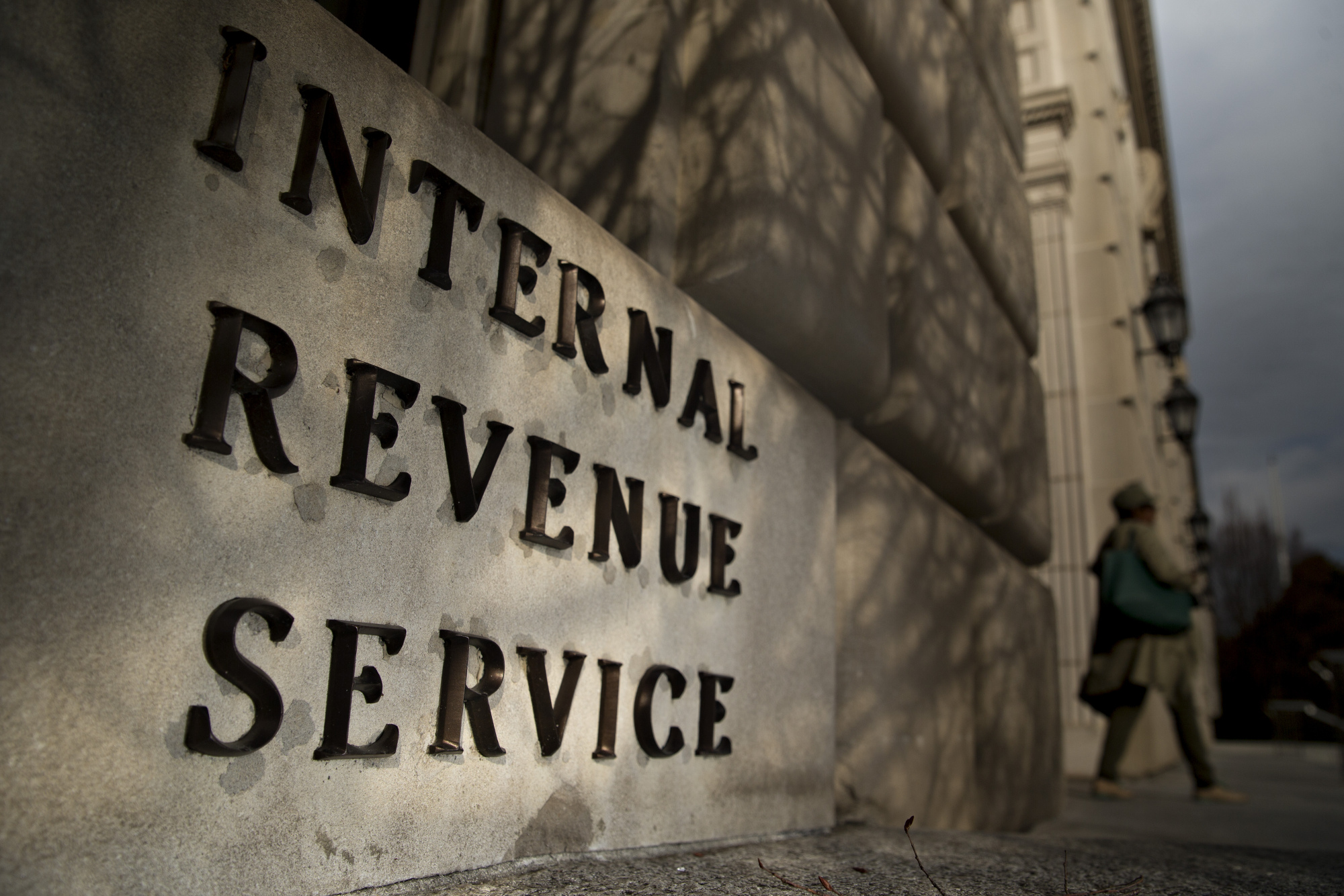 A woman walks out of the Internal Revenue Service (IRS) headquarters building in Washington.