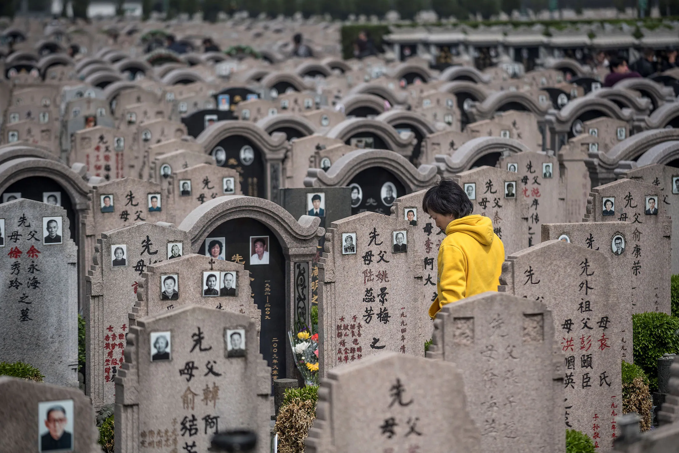 A woman visits a grave&nbsp;at a cemetery in Shanghai.