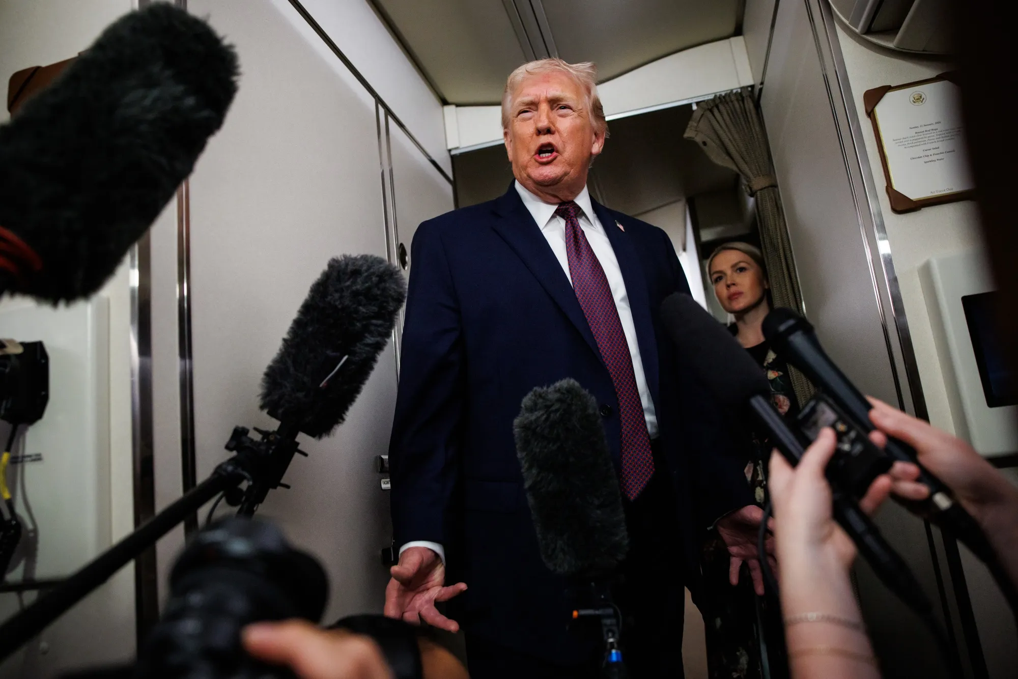 President Donald Trump speaks to&nbsp;members of the press aboard Air Force One on Jan. 11.