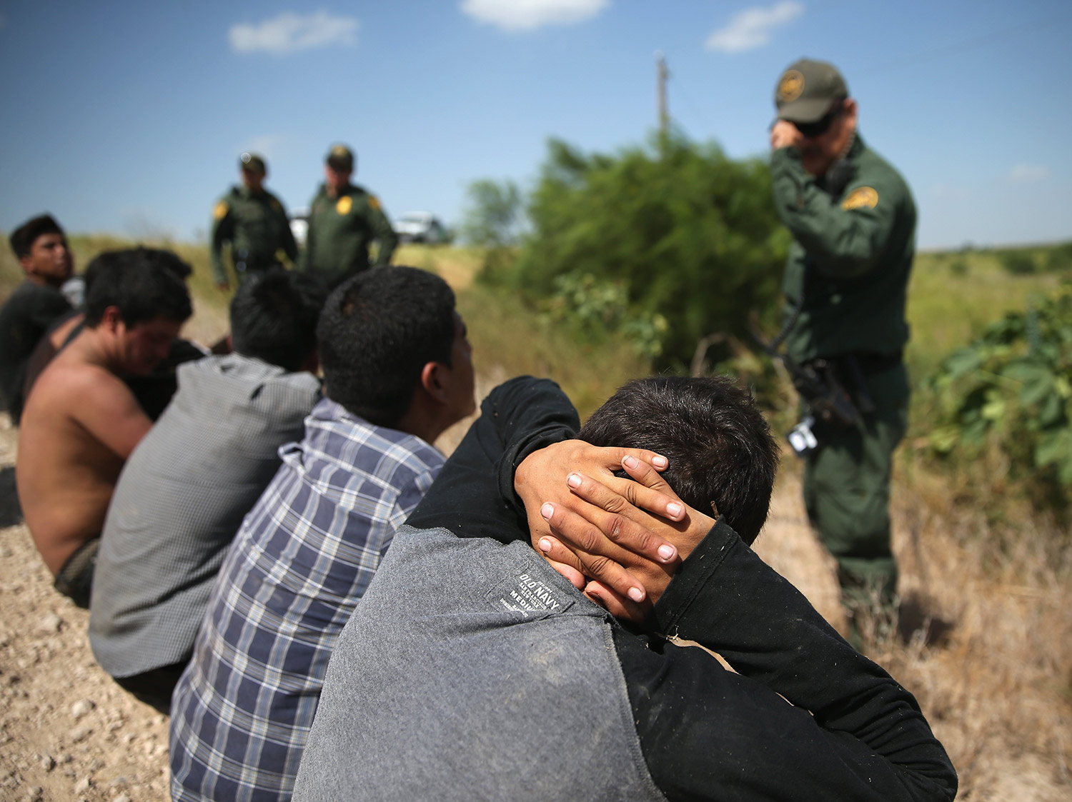 U.S. Border Patrol agents detain undocumented immigrants after they crossed the border from Mexico into the United States on August 7, 2015 in McAllen, Texas.