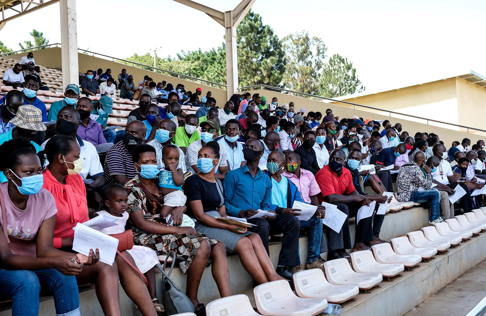 People wait for Covid-19 vaccination&nbsp;at Kololo Ceremonial Grounds in Kampala.