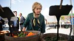 Hillary Clinton views a selection of peppers at a farmers market in Davenport, Iowa, on Oct. 6, 2015.
