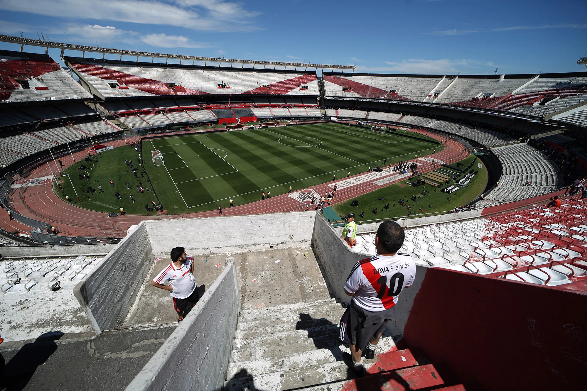 Fans of River Plate look at an empty field after the match was postponed.