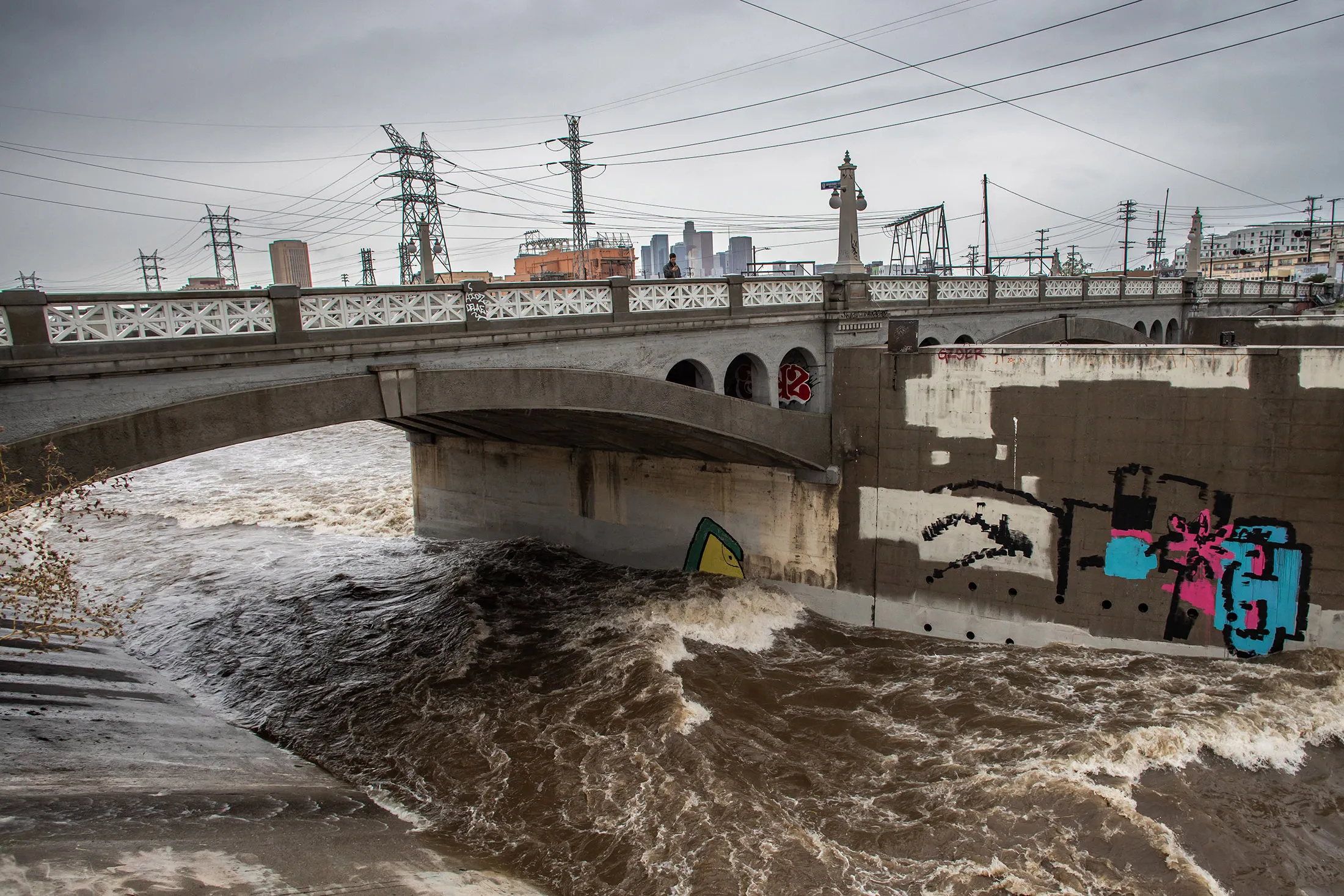 Strong currents on the Los Angeles River at the Main Street bridge in downtown in Los Angeles, California on Nov. 15.