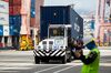 A worker inspects a container shipment as a truck carrying a container drives through the Busan Port Terminal (BPT) at the Port of Busan in Busan, South Korea, on Tuesday, July 30, 2019. A trade dispute between South Korea and Japan is threatening to spiral out of control, and both governments want the White House on their side.