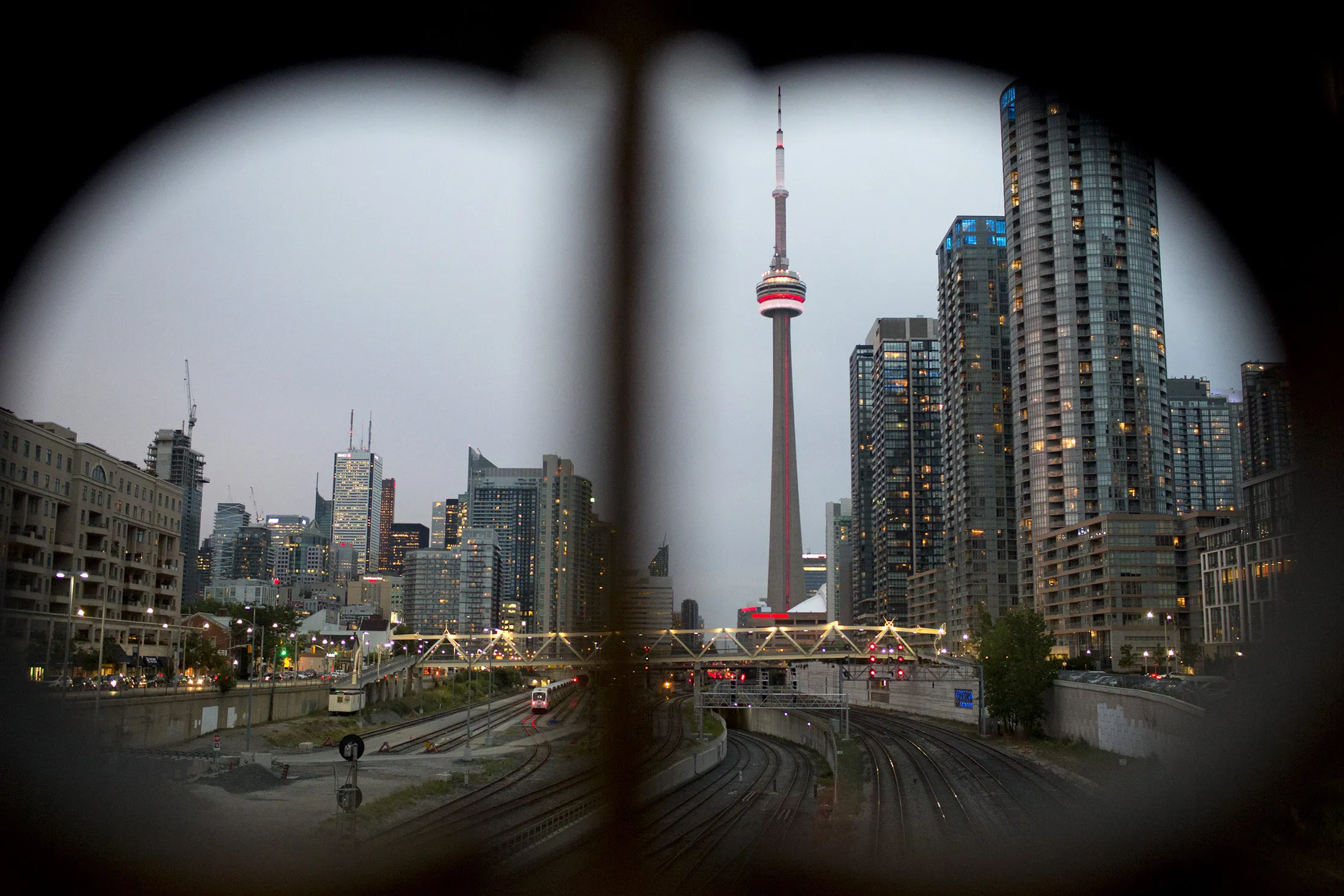 The CN Tower, center, stands near residential and commercial buildings in the financial district of Toronto, Ontario.
