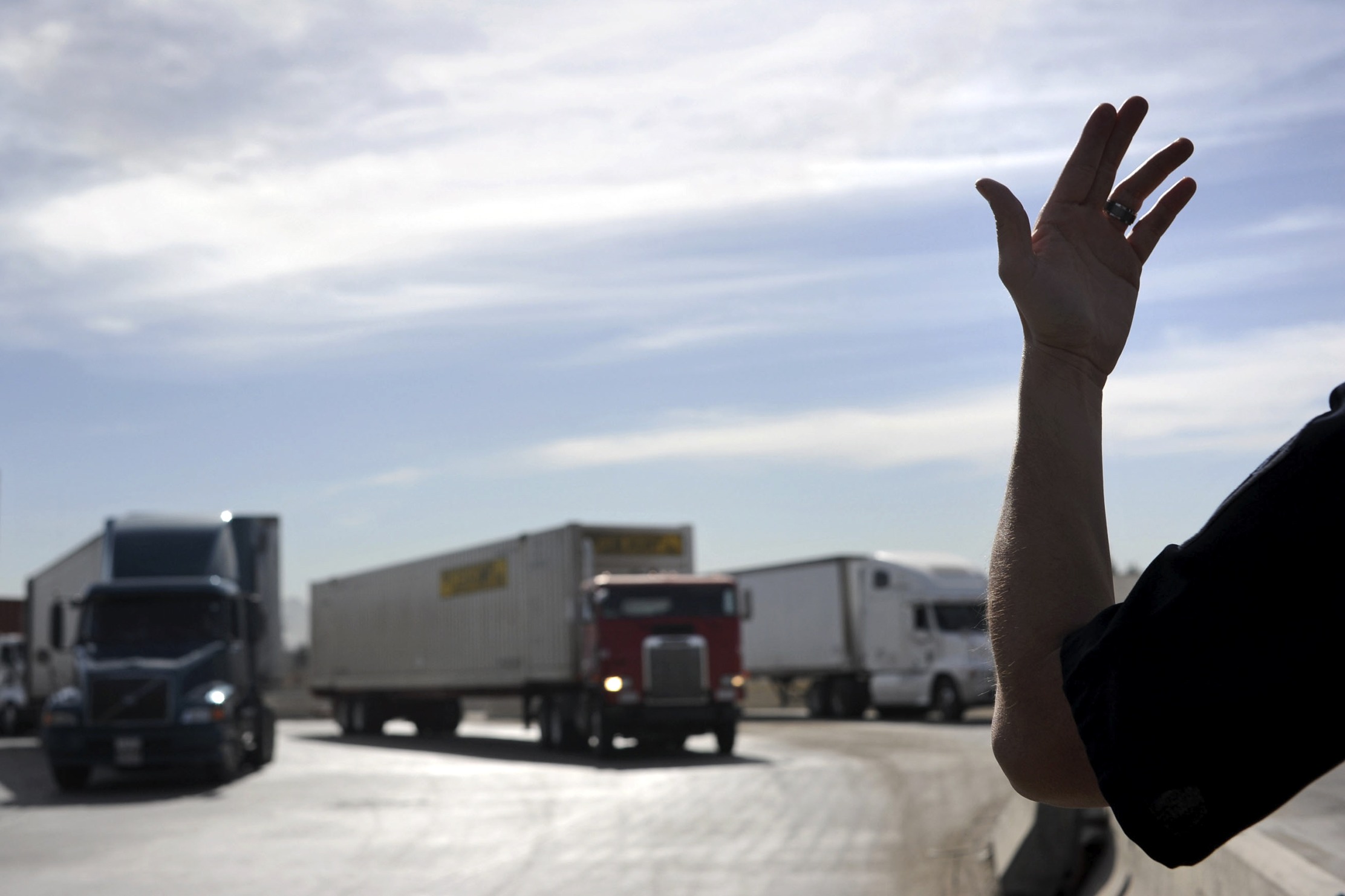 A U.S. Customs and Border Protection officer directs trucks entering the United States from Mexico&nbsp;in San Diego, California.