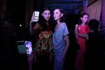 Two models take a 'selfie' backstage during a fashion show in Beijing.
