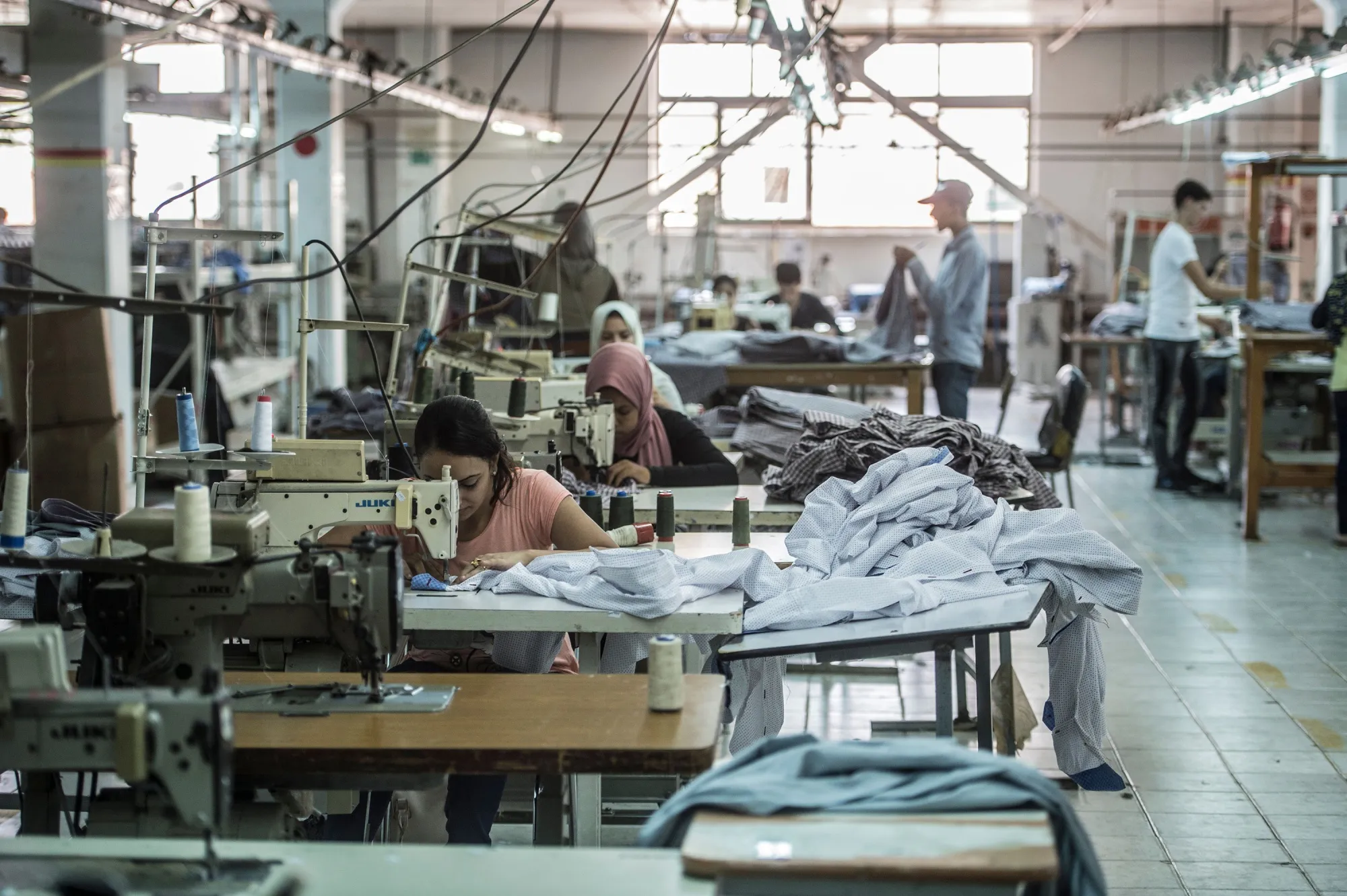 Tailors work in a textile factory north of Cairo.