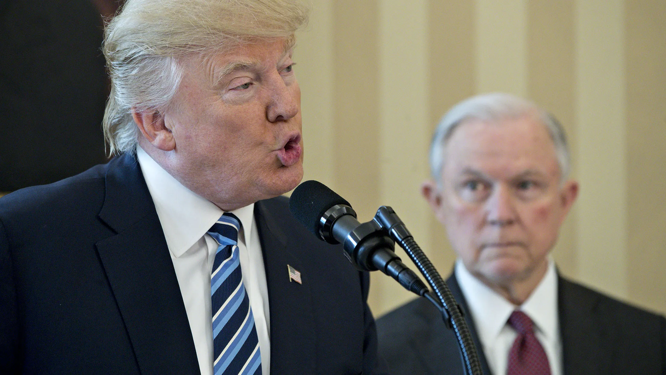 President Donald Trump speaks as Jeff Sessions, U.S. attorney general, listens before being sworn in at the White House in Washington on Feb. 9, 2017.

