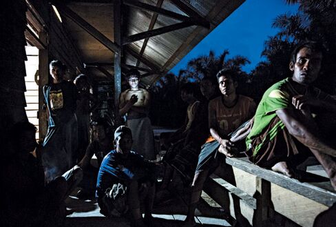 Workers at PT 198 in Berau outside their residential barracks. They must walk 2 kilometers for clean running water
