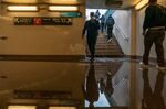 Commuters walk into a flooded 3rd Avenue subway station on September 2, 2021.&nbsp;