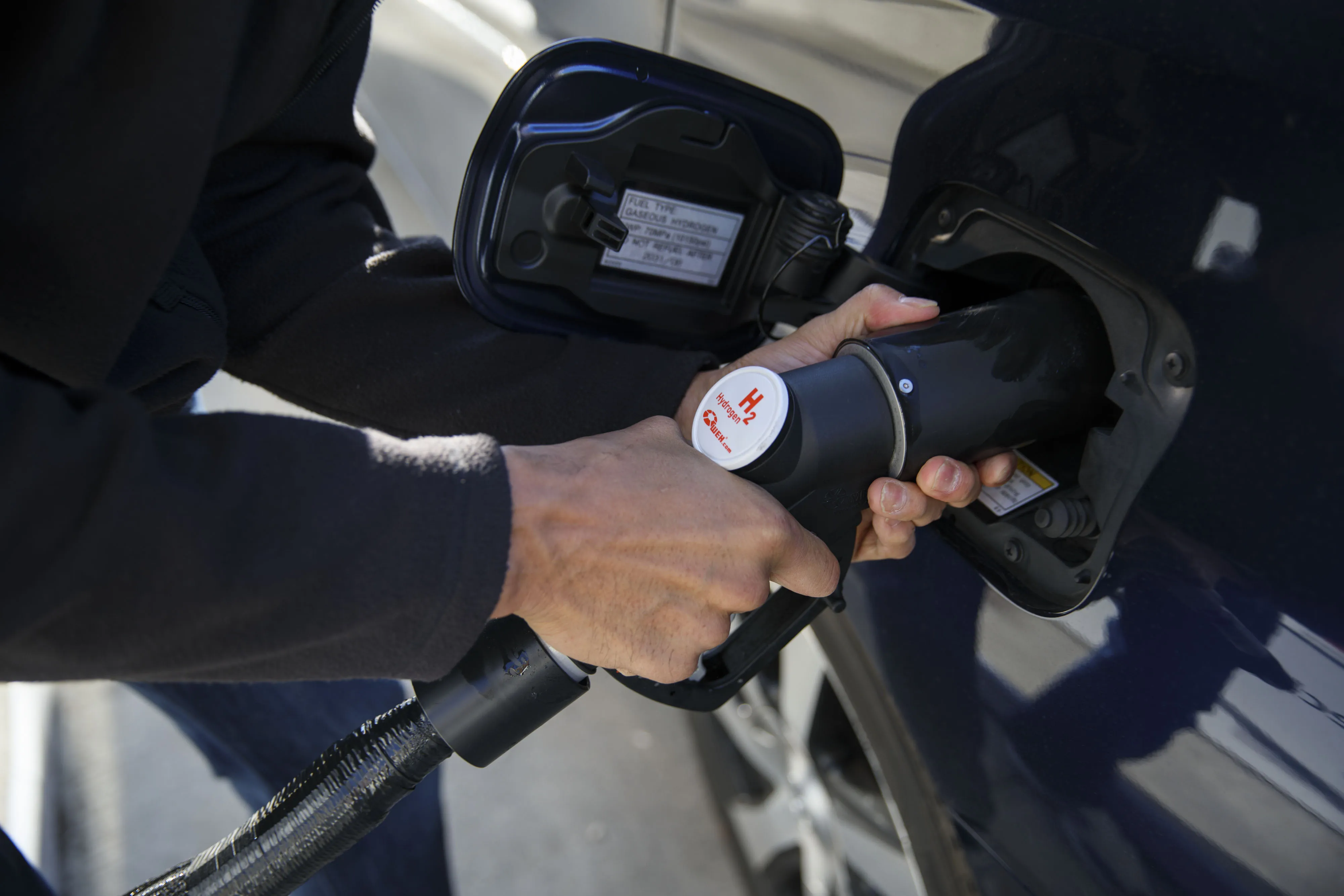 A customer refuels a hydrogen fuel cell vehicle at a hydrogen fueling station in Irvine, California.