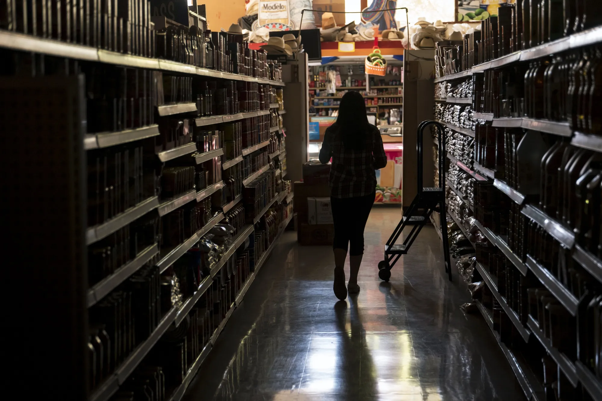 A customer shops for groceries during a blackout in Napa on Oct. 9.