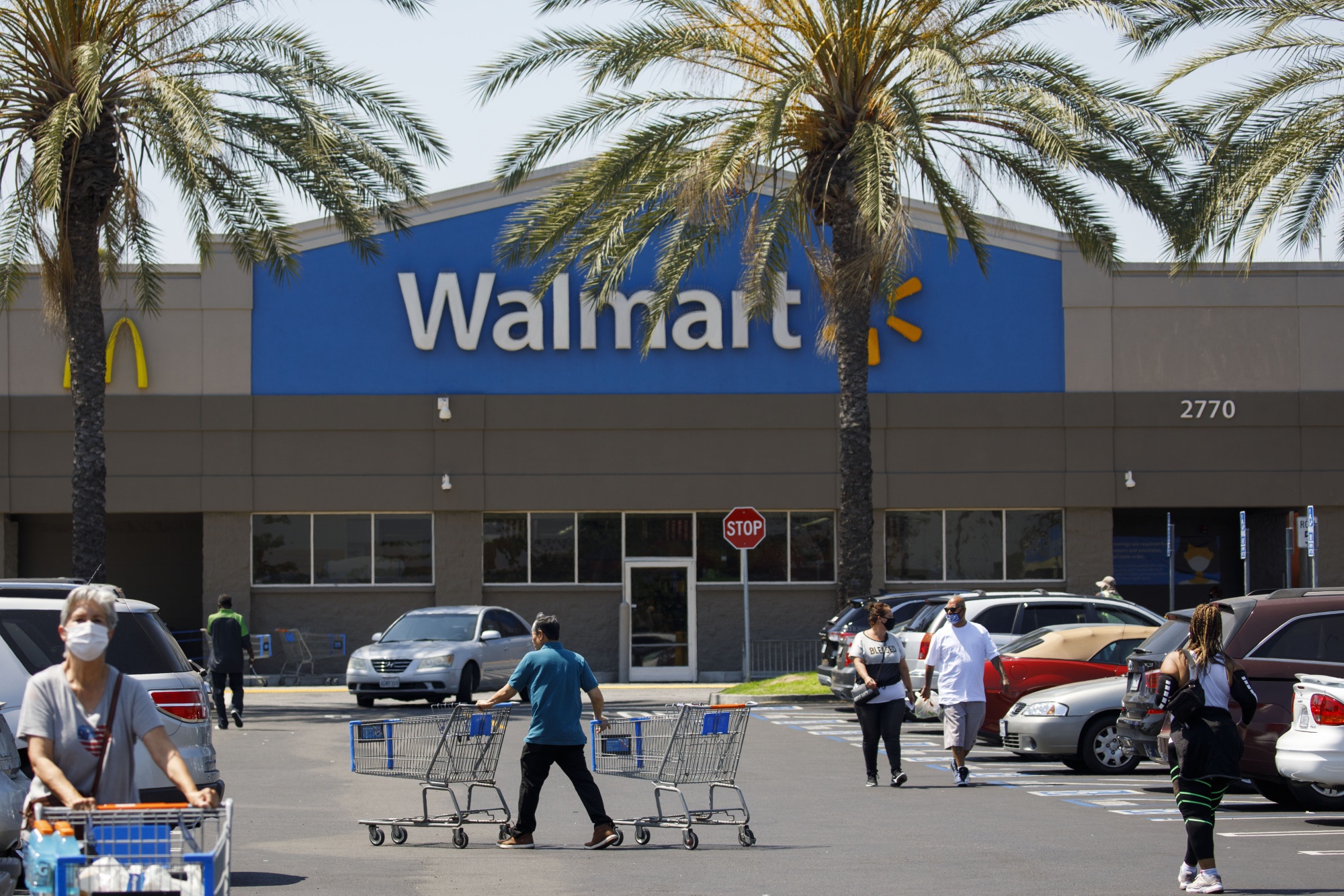 Shoppers&nbsp;leave a Walmart store in Lakewood, Calif.