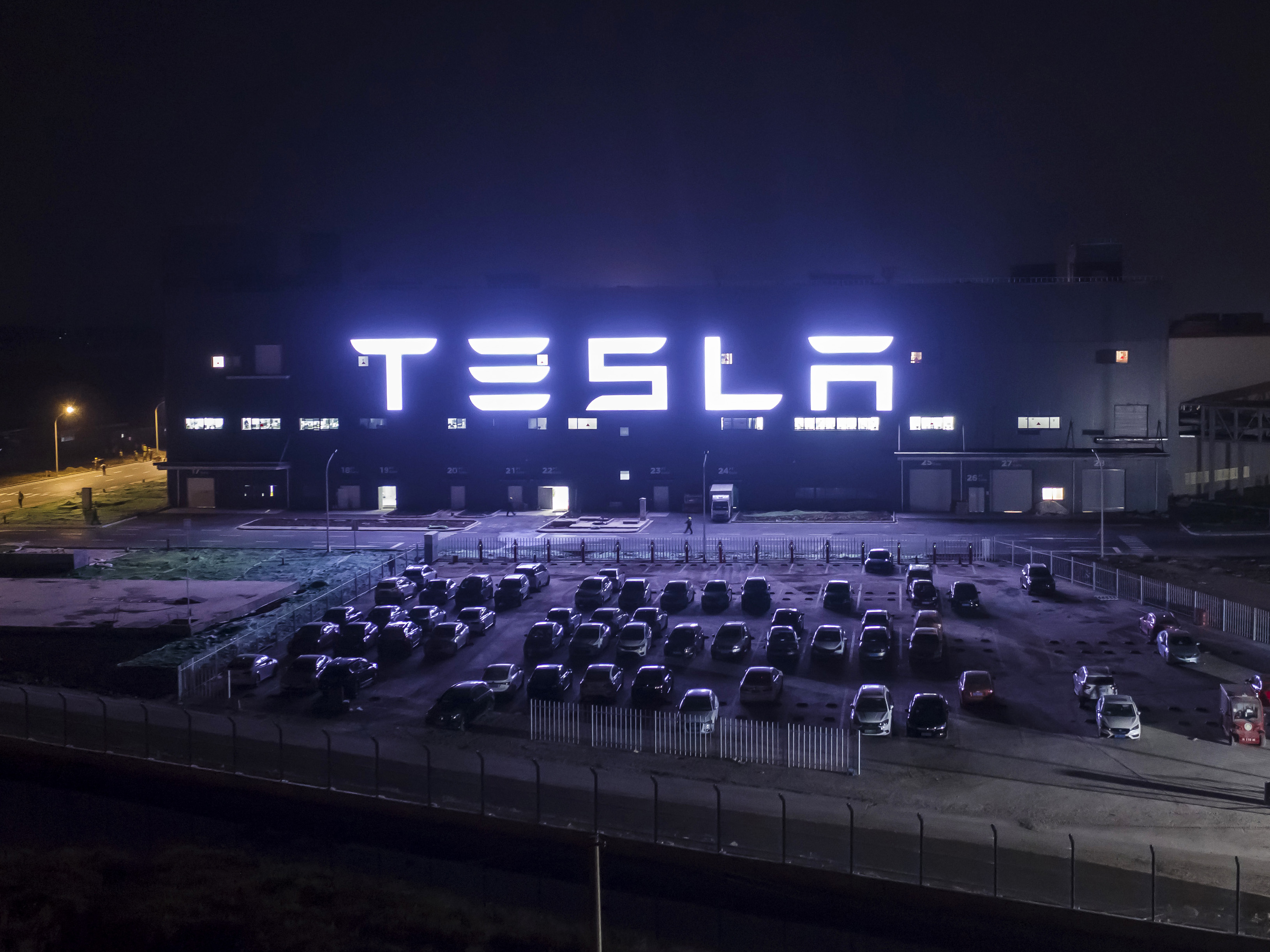 The Tesla Inc. Gigafactory stands illuminated at night in Shanghai.