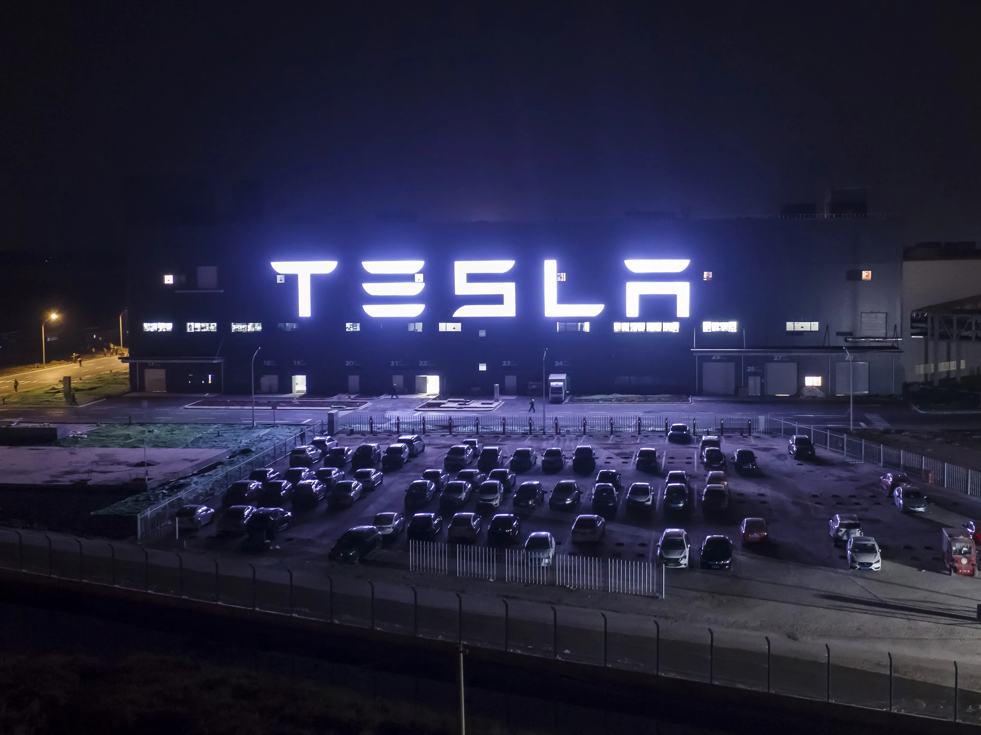 The Tesla Inc. Gigafactory stands illuminated at night in Shanghai.