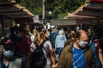 Shoppers wearing protective face masks pass food stalls at the Edgar Quinet market in Paris, France, on&nbsp;Sept. 9.