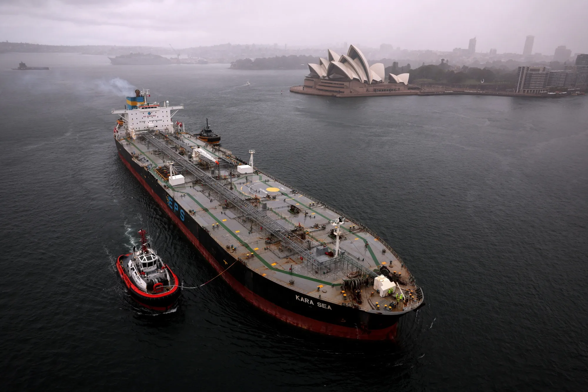 A tugboat escorts a crude oil tanker in Sydney.