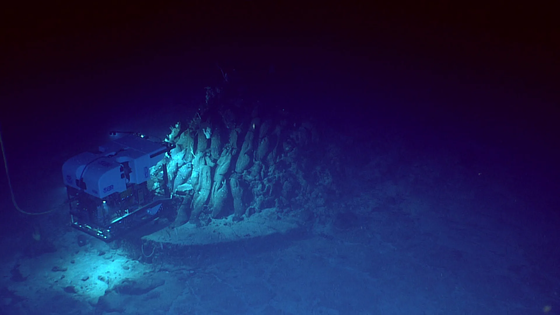 Remotely operated vehicle Deep Discoverer images an outcrop on the seafloor. Scientists still have a relatively poor understanding of deep&nbsp;sea ecosystems, including the harm mining them could cause. Photo:&nbsp;NOAA Ocean Exploration