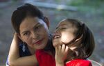Araceli Ramos Bonilla holds her 5-year-old daughter, Alexa, on her lap during an interview in a park in San Miguel, El Salvador, on Aug. 18, 2018.