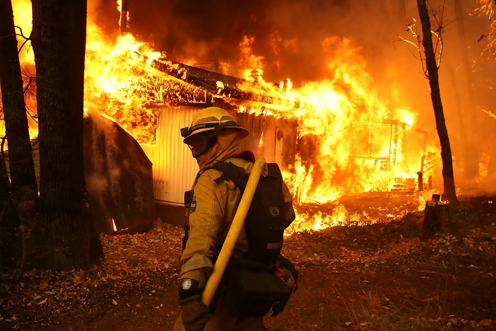 A firefighter monitors a burning home during last November’s Camp Fire in Northern California.