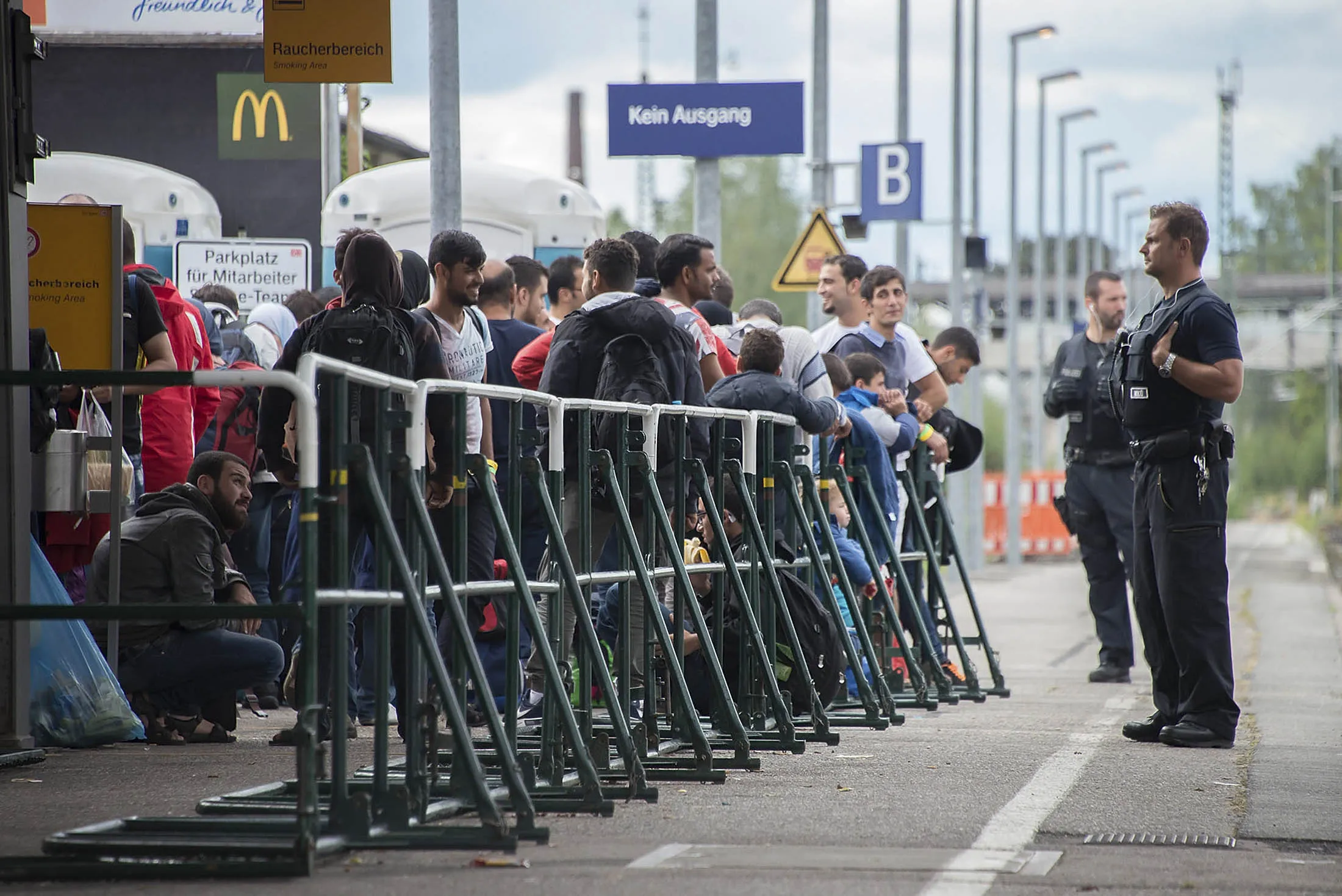 Migrants who have arrived on foot from Austria cross one of the borders to wait for a train to Munich in Freilassing, Germany on September 18, 2015.
