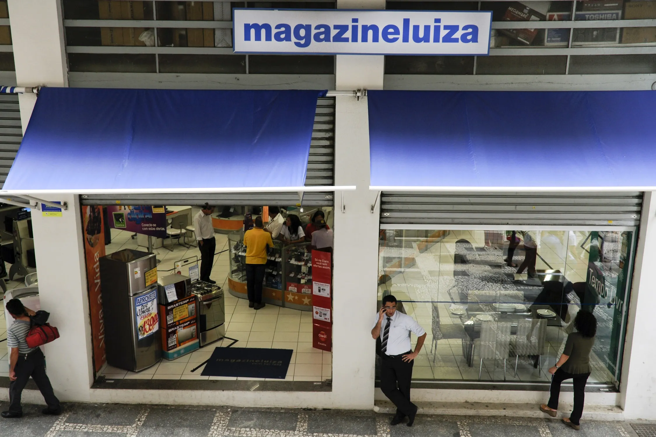 
Pedestrians pass in front of a Magazine Luiza SA store in Sao Paulo.
