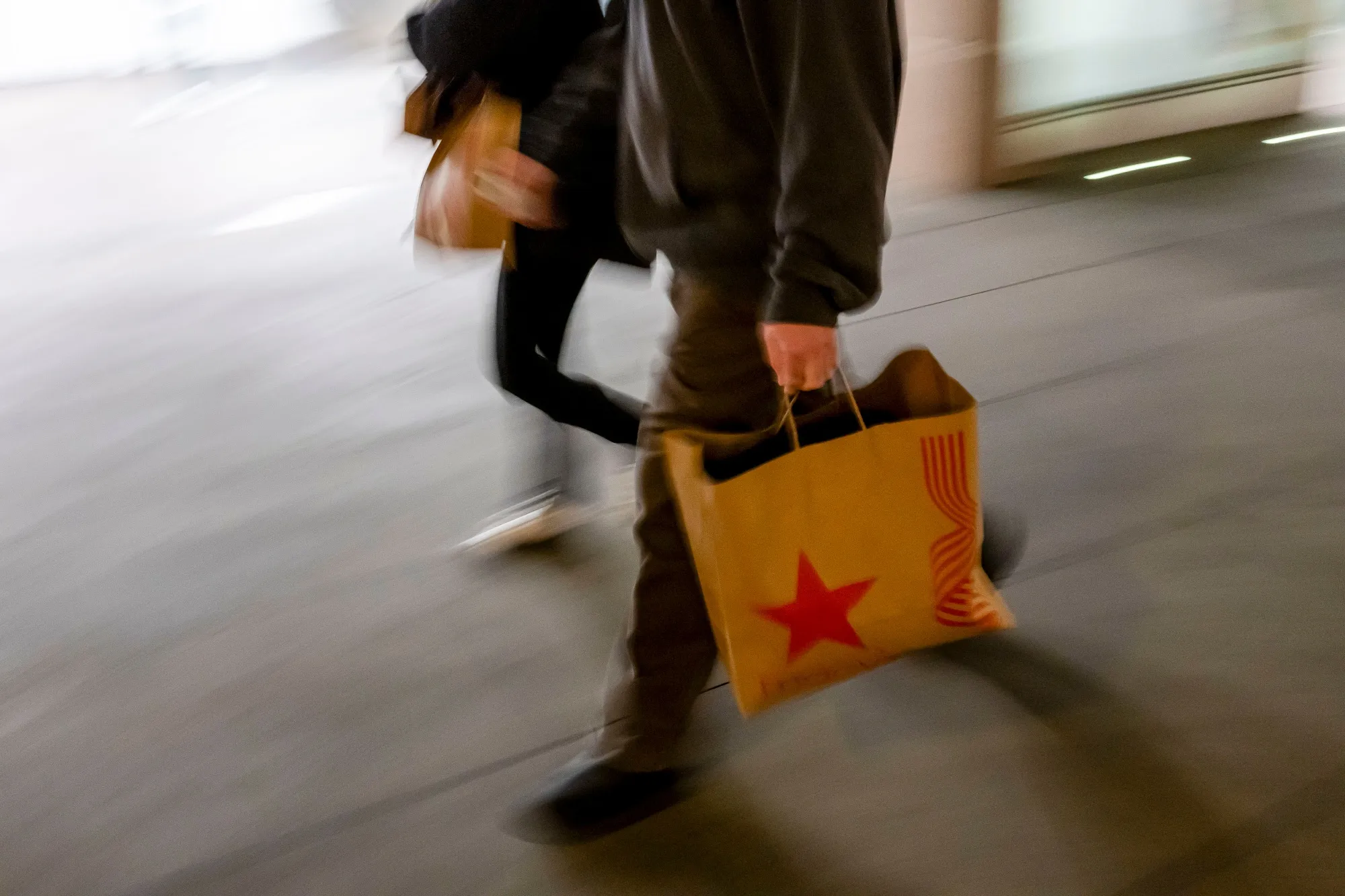 A shopper carries a Macy's bag in San Francisco, California.