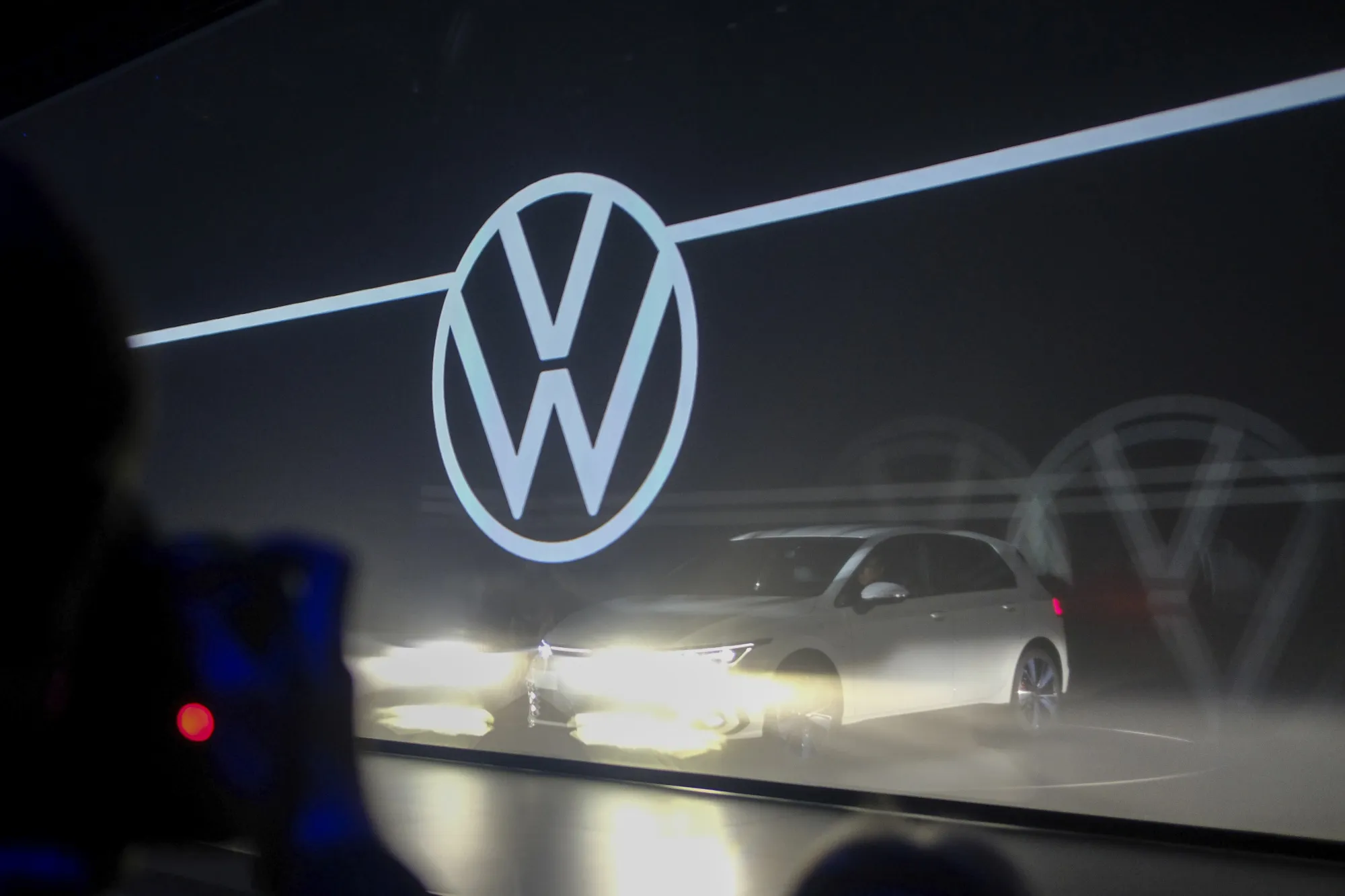 The VW logo sits on a screen at the world premiere of the new Golf automobile at the automaker's headquarters in Wolfsburg, on Oct. 24, 2019.&nbsp;