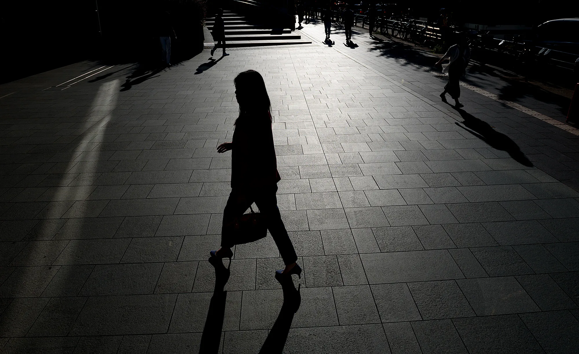A woman walks near the Roppongi Hills complex in Tokyo.
