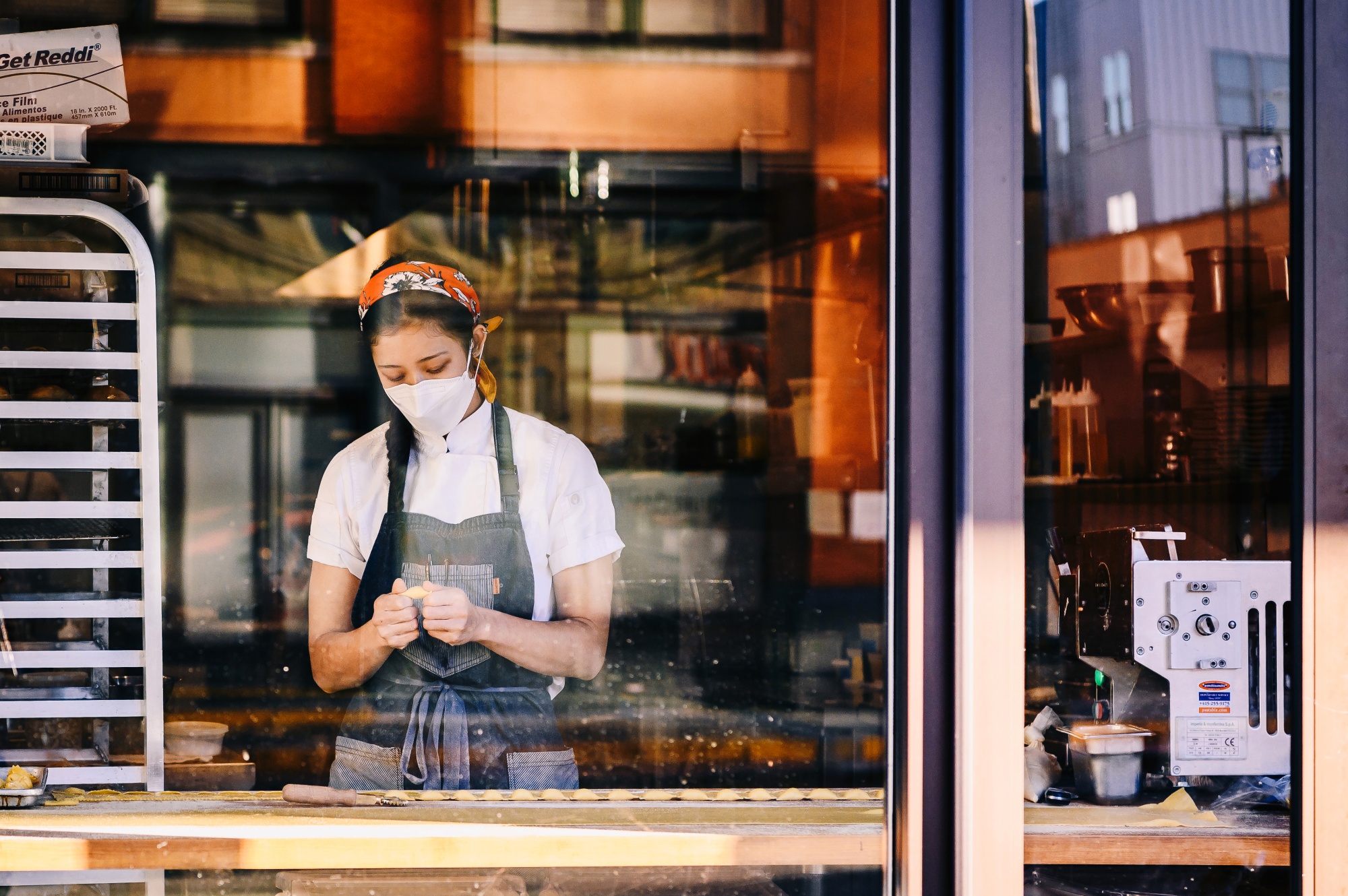 A worker wears a protective mask while preparing food at a restaurant in Memphis, Tennessee.