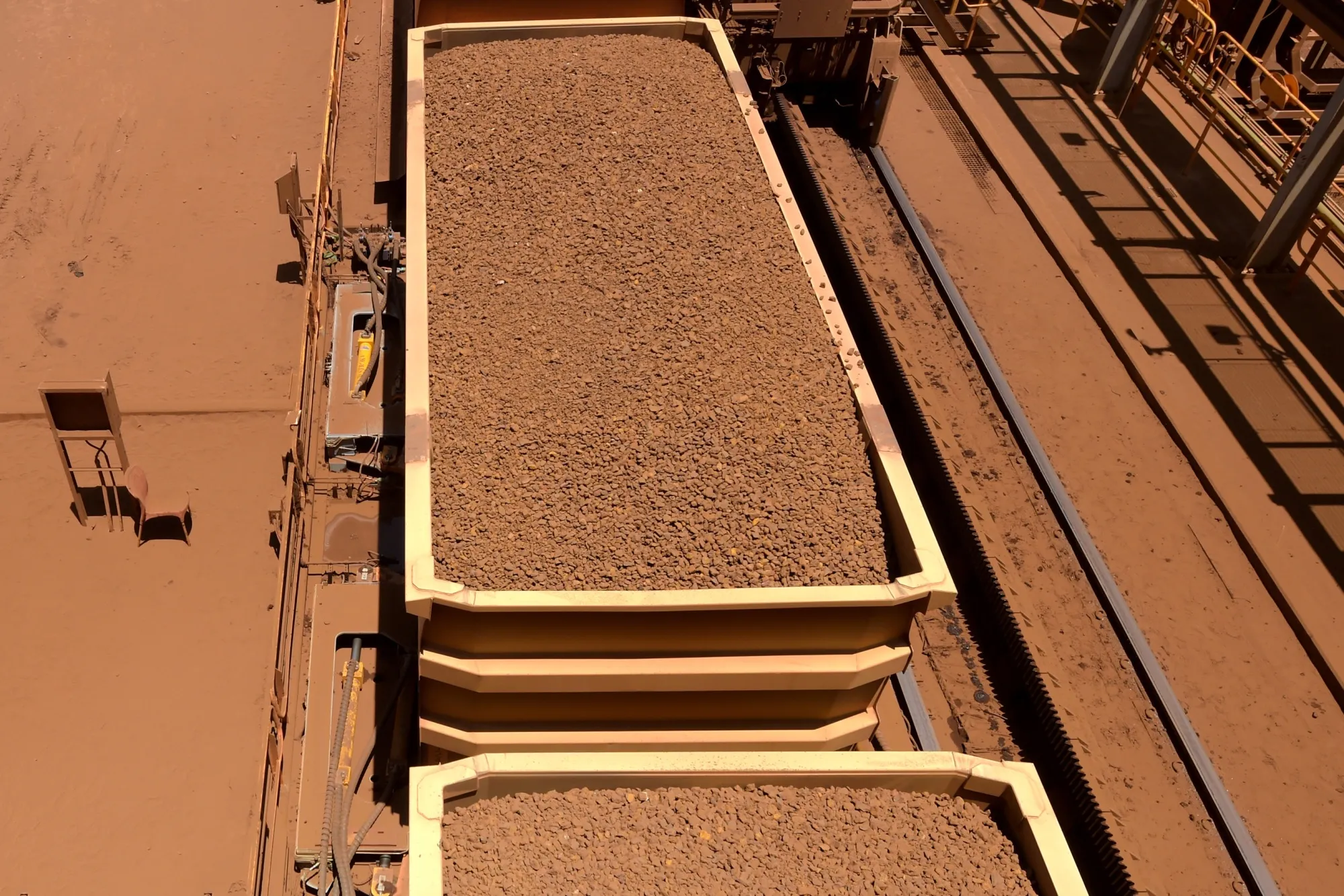 Train carriages wait to unload iron ore at Rio Tinto Group's port facility in Karratha, Western Australia.