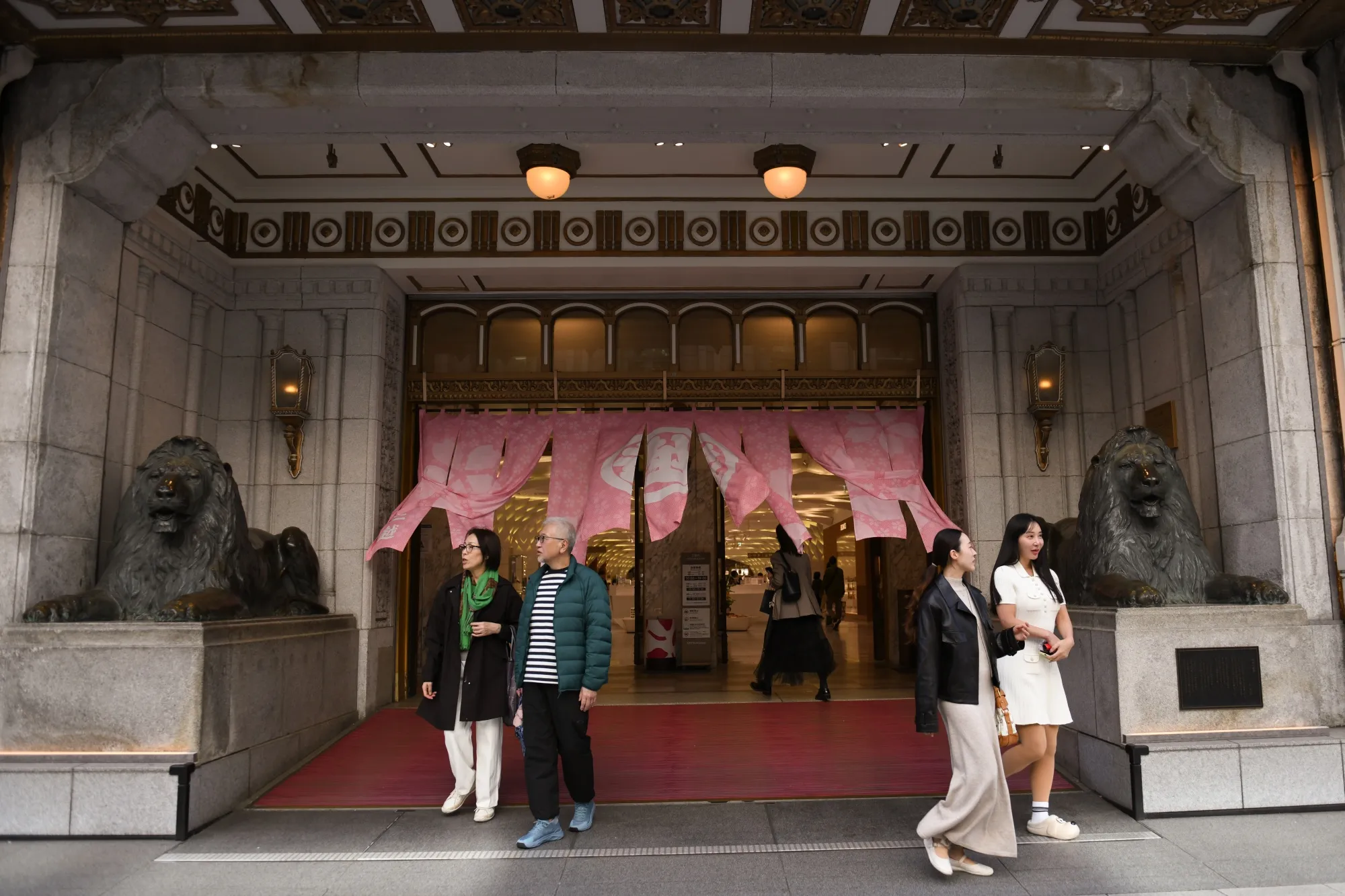 Shoppers in front of Mitsukoshi department store in Tokyo, Japan.