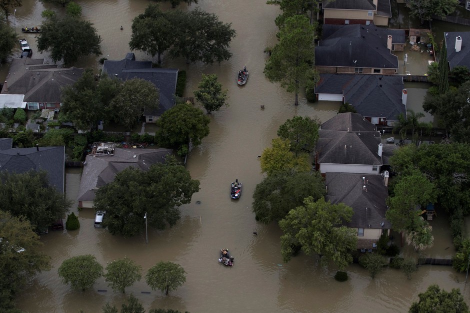 Residents are evacuated through flood waters caused by Harvey in West Houston, August 30, 2017.