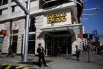Pedestrians walk past a Wells Fargo & Co. bank branch in Los Angeles, California.